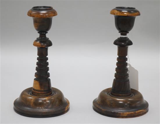 A pair of lignum vitae candlesticks